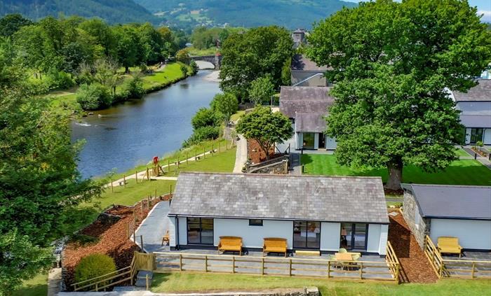 Holiday lodge with river and mountains in background